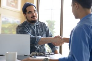 Businessmen shaking hands for business agreement in office